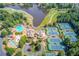 Overhead view of the community pool and tennis courts surrounded by lush landscaping and a nearby lake at 5004 Gunnison Trce, Suwanee, GA 30024