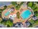 Aerial view of large community pool area with ample lounge chairs, splash pad and well-maintained landscaping at 5004 Gunnison Trce, Suwanee, GA 30024