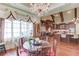 Elegant dining area features a decorative chandelier, ornate windows, and views into the gourmet kitchen at 5004 Gunnison Trce, Suwanee, GA 30024