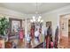 Formal dining area featuring hardwood floors, chandelier lighting, and detailed woodwork, ideal for entertaining guests at 5004 Gunnison Trce, Suwanee, GA 30024