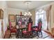 Elegant dining room with chandelier, ornate chairs, and hardwood floors, perfect for hosting memorable gatherings at 5004 Gunnison Trce, Suwanee, GA 30024