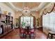 Elegant dining room with chandelier lighting, hardwood floors, designer curtains and traditional furnishings at 5004 Gunnison Trce, Suwanee, GA 30024