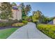 Long driveway leading to a beautiful home with mature trees at 5004 Gunnison Trce, Suwanee, GA 30024