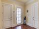 Welcoming entryway featuring hardwood floors and white doors at 5004 Gunnison Trce, Suwanee, GA 30024