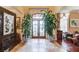 Elegant foyer with tile floors, large potted plants, and decorative furnishings at 5004 Gunnison Trce, Suwanee, GA 30024