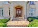 Elegant stone front entrance with ornate wood doors and stone entryway at 5004 Gunnison Trce, Suwanee, GA 30024