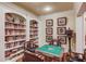 Entertainment room with large bookcase and chairs at game table at 5004 Gunnison Trce, Suwanee, GA 30024