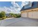 Home with garage and driveway surrounded by mature trees and landscaped shrubs at 5004 Gunnison Trce, Suwanee, GA 30024