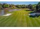 Beautifully maintained golf course with sand traps nestled next to a tranquil lake, offering a scenic view at 5004 Gunnison Trce, Suwanee, GA 30024