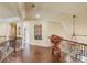 Second floor hallway featuring hardwood floors and iron railings at 5004 Gunnison Trce, Suwanee, GA 30024