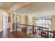 Hallway featuring hardwood floors, columns, and a chandelier at 5004 Gunnison Trce, Suwanee, GA 30024