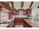 Gourmet kitchen featuring stainless steel appliances, custom cabinetry, a large island and stone countertops at 5004 Gunnison Trce, Suwanee, GA 30024