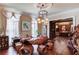 Unique living room area featuring custom woodwork table and chairs, chandelier, and lots of natural light at 5004 Gunnison Trce, Suwanee, GA 30024