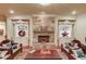 Elegant living room featuring a stone fireplace, custom built-ins, and unique asian-inspired decor at 5004 Gunnison Trce, Suwanee, GA 30024