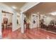 Open-concept living space with hardwood floors, stone fireplace, and seamless transition to other areas at 5004 Gunnison Trce, Suwanee, GA 30024