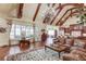 Spacious living room features vaulted ceiling, wood beams, leather furniture, and an abundance of natural light at 5004 Gunnison Trce, Suwanee, GA 30024