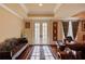 Cozy sitting area featuring hardwood floors, a custom rug, and natural light at 5004 Gunnison Trce, Suwanee, GA 30024