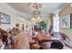 Spacious living area showcasing custom wooden furniture, chandelier lighting, and hardwood floors at 5004 Gunnison Trce, Suwanee, GA 30024