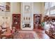 Elegant living area with hardwood floors, fireplace, built-in bookshelves and custom wood sculpture at 5004 Gunnison Trce, Suwanee, GA 30024