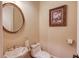 Charming powder room features unique floral-patterned sink, decorative mirror, and soft neutral color palette at 5004 Gunnison Trce, Suwanee, GA 30024