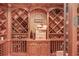 Extensive custom wood wine cellar featuring ample storage for wine bottles and accessories at 5004 Gunnison Trce, Suwanee, GA 30024