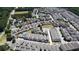Aerial view of a neighborhood with well-maintained homes, green spaces and tennis courts at 690 Stickley Oak Way, Woodstock, GA 30189