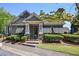 Charming community clubhouse is framed by landscaped bushes and stone columns, offering a welcoming entrance to a community amenity at 690 Stickley Oak Way, Woodstock, GA 30189