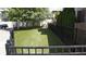 Spacious backyard featuring lush green turf and a sleek black fence at 690 Stickley Oak Way, Woodstock, GA 30189