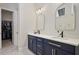 Stylish bathroom with double vanity, modern mirrors, and walk-in closet access at 690 Stickley Oak Way, Woodstock, GA 30189