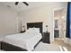 Bedroom with large windows, soft lighting, and adjacent bathroom at 690 Stickley Oak Way, Woodstock, GA 30189