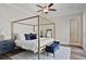 Spacious bedroom with a four-poster bed, ceiling fan and elegant decor at 690 Stickley Oak Way, Woodstock, GA 30189