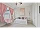 Cozy bedroom with neutral walls, large window, modern décor, and comfortable daybed at 690 Stickley Oak Way, Woodstock, GA 30189
