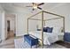 Luxurious bedroom with a four-poster bed, bench, and a ceiling fan at 690 Stickley Oak Way, Woodstock, GA 30189