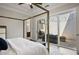 Bedroom with a four-poster bed and sliding door to outdoor patio with furniture at 690 Stickley Oak Way, Woodstock, GA 30189