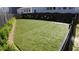 Well-maintained community dog park featuring manicured landscaping and artificial turf, creating a secure and attractive space at 690 Stickley Oak Way, Woodstock, GA 30189