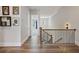 Bright hallway with hardwood floors, decorative wall art, and modern staircase at 690 Stickley Oak Way, Woodstock, GA 30189