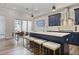 Well lit kitchen boasts modern design, stainless steel appliances, and an expansive island at 690 Stickley Oak Way, Woodstock, GA 30189