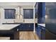Close up of the modern kitchen with stainless steel appliances and a sleek white countertop at 690 Stickley Oak Way, Woodstock, GA 30189