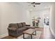 Comfortable living room with hardwood floors, modern furniture, and a bar area at 690 Stickley Oak Way, Woodstock, GA 30189
