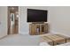 Comfortable living room area featuring a large TV and a modern coffee table at 690 Stickley Oak Way, Woodstock, GA 30189