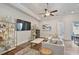 Bright living room with wood floors, a large sectional sofa, and decorative shelving at 690 Stickley Oak Way, Woodstock, GA 30189