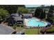 Relaxing community pool featuring comfortable lounge chairs, umbrellas, and people enjoying themselves in a meticulously maintained surrounding at 690 Stickley Oak Way, Woodstock, GA 30189