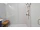 Elegant walk-in shower with herringbone tile and a wooden bench at 690 Stickley Oak Way, Woodstock, GA 30189