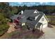 Aerial shot of the house with a manicured lawn, screened porch, and a luxurious hot tub at 200 Suffolk Way, Mcdonough, GA 30252
