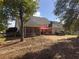 Expansive backyard featuring a patio, hot tub, shade sail and screened in porch creates a tranquil outdoor oasis at 200 Suffolk Way, Mcdonough, GA 30252