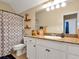 Bathroom featuring a vanity with sink, decorative shelving and patterned shower curtain at 200 Suffolk Way, Mcdonough, GA 30252