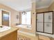 Bright bathroom featuring a soaking tub, walk-in shower and a large vanity with a neutral color palette at 200 Suffolk Way, Mcdonough, GA 30252