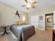 Comfortable bedroom with a queen bed, ceiling fan, and ensuite bathroom access at 200 Suffolk Way, Mcdonough, GA 30252