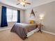 Inviting bedroom featuring a cozy bed, ceiling fan, and ample natural light from the window at 200 Suffolk Way, Mcdonough, GA 30252