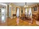 Inviting dining area with wood table, chairs, and ample natural light from curtained windows at 200 Suffolk Way, Mcdonough, GA 30252